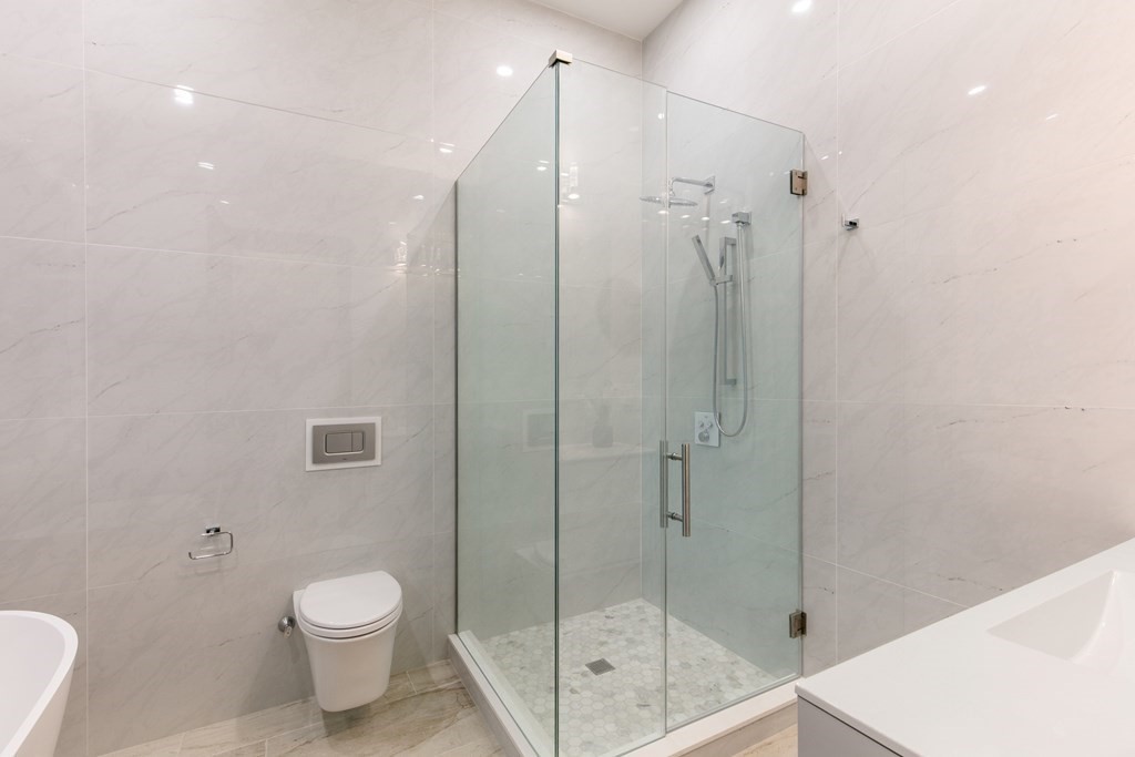 88 Dover Street, Unit 2 Somerville, MA 02144 - Photo 23 of 36 a bathroom with a shower a toilet and sink