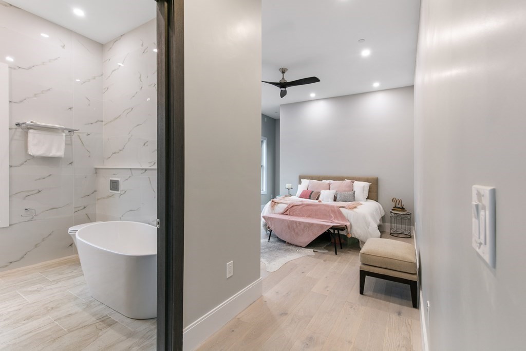 88 Dover Street, Unit 2 Somerville, MA 02144 - Photo 25 of 36 a bedroom with a bed and a couch