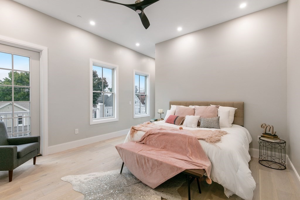 88 Dover Street, Unit 2 Somerville, MA 02144 - Photo 26 of 36 a bedroom with a large bed and wooden floor