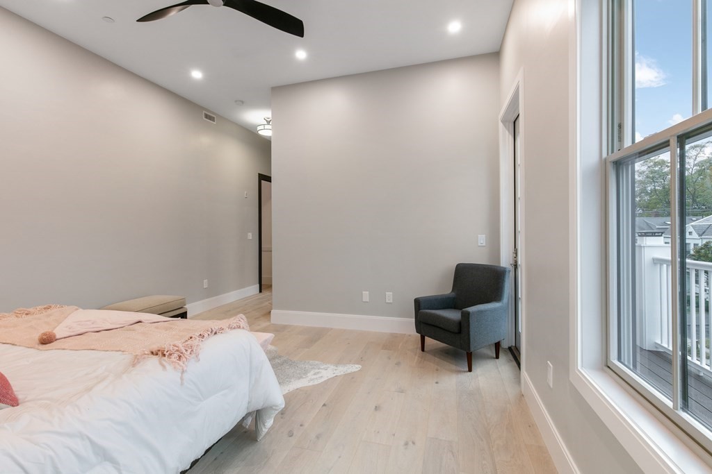 88 Dover Street, Unit 2 Somerville, MA 02144 - Photo 27 of 36 a bedroom with a bed and a mirror