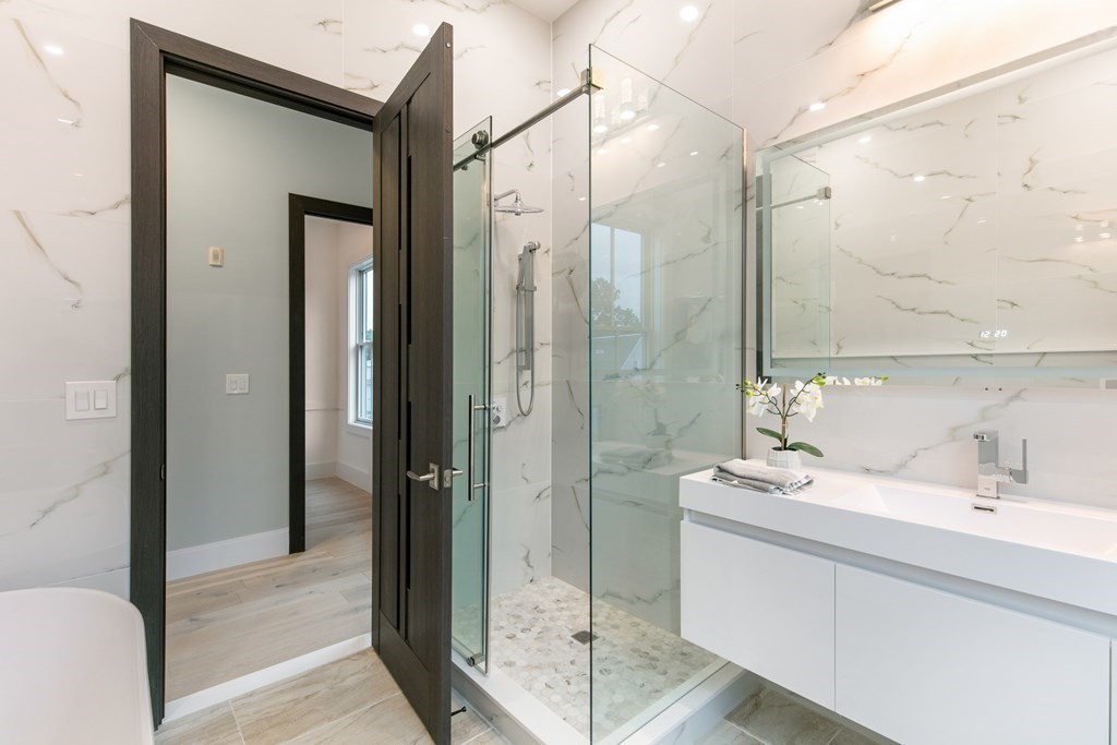 88 Dover Street, Unit 2 Somerville, MA 02144 - Photo 29 of 36 a bathroom with a double vanity sink mirror and shower