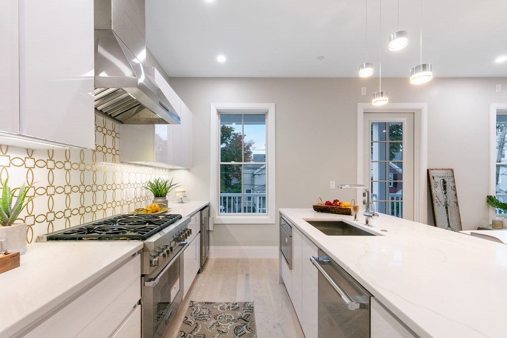 88 Dover Street, Unit 2 Somerville, MA 02144 - Photo 5 of 36 a kitchen with a sink cabinets and window