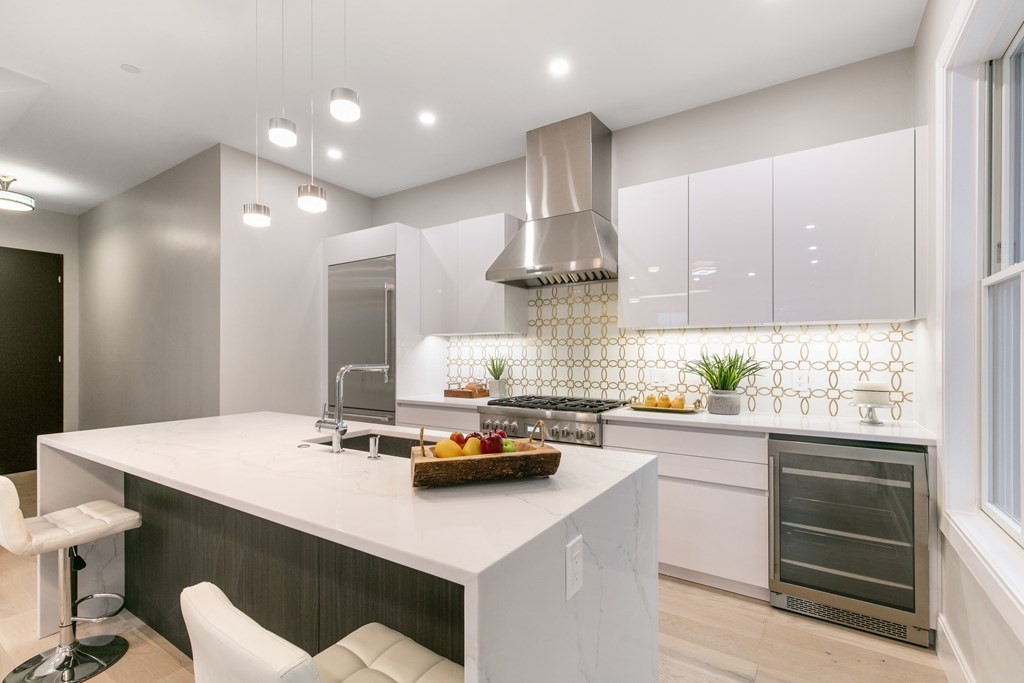 88 Dover Street, Unit 2 Somerville, MA 02144 - Photo 6 of 36 a kitchen with kitchen island stainless steel appliances a sink and stove