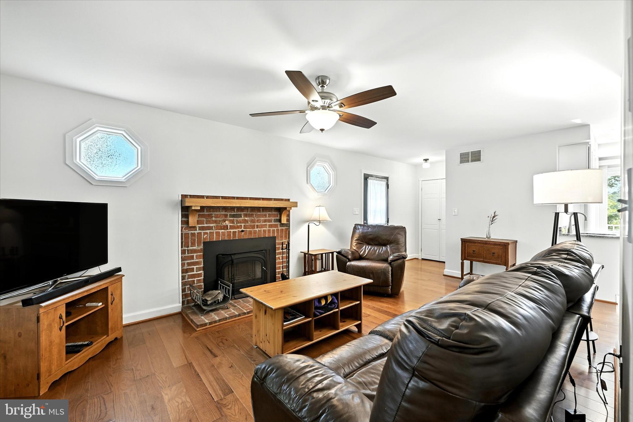 3111 Northwind Road Baltimore, MD 21234 - Photo 20 of 81 a living room with furniture a flat screen tv and a fireplace