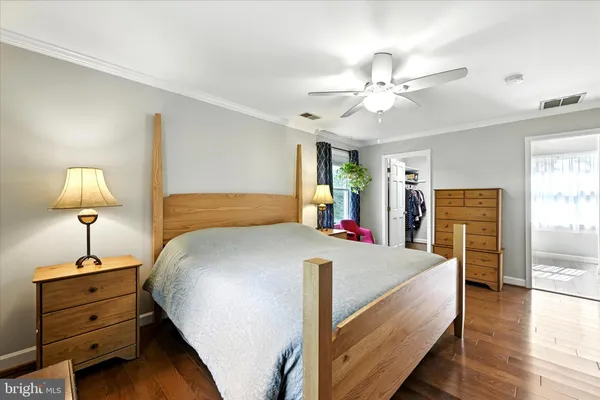 a bed sitting in a spacious bedroom next to a window