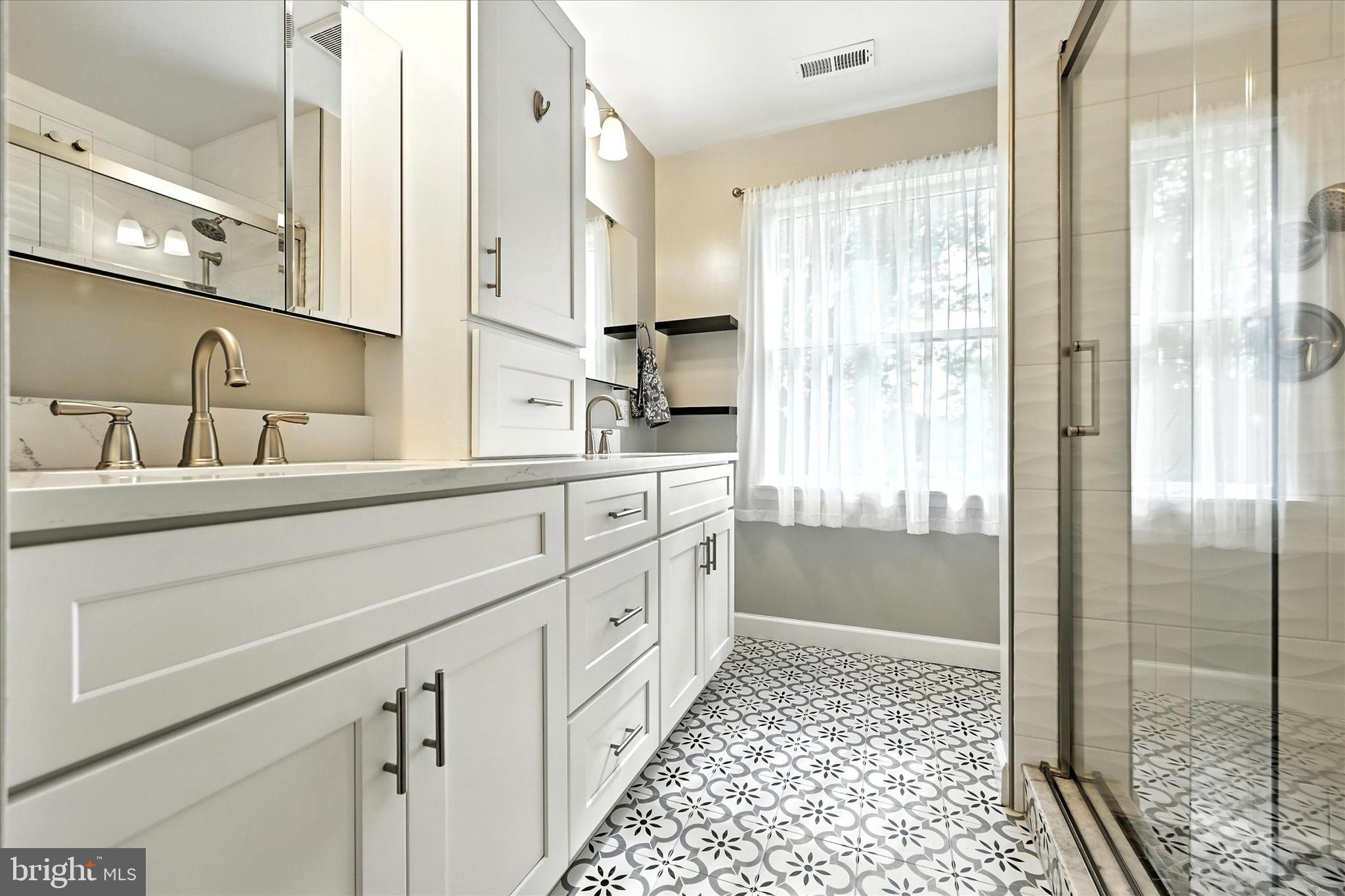 3111 Northwind Road Baltimore, MD 21234 - Photo 23 of 81 a bathroom with a double vanity sink a mirror and a shower