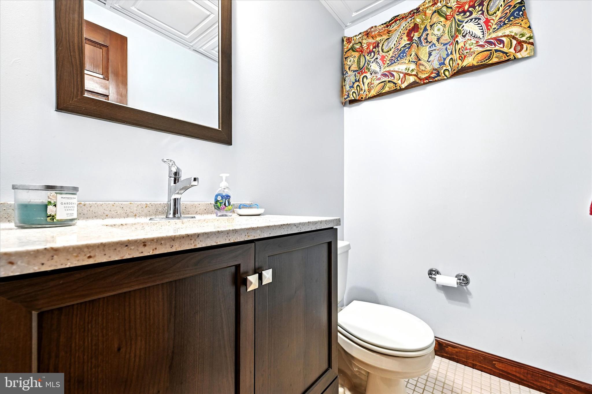 3111 Northwind Road Baltimore, MD 21234 - Photo 30 of 81 a bathroom with a granite countertop toilet sink and mirror