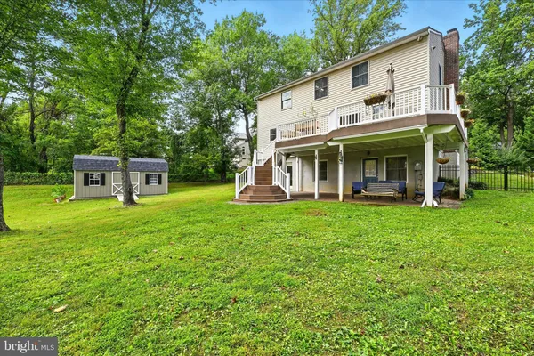 a view of a house with backyard porch and sitting area