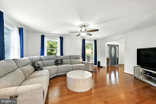 a kitchen with stainless steel appliances granite countertop a sink a stove a refrigerator cabinets and chairs