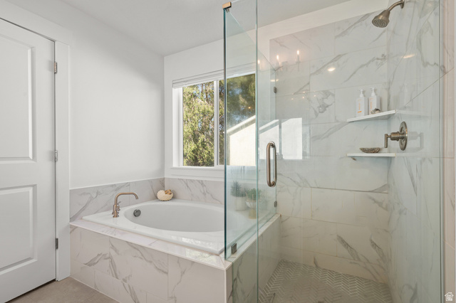 2706 West Maple Street, Unit 285 Mapleton, UT 84664 - Photo 20 of 36 Soaking tub with a bronze-finish faucet, surrounded by marble-look tile