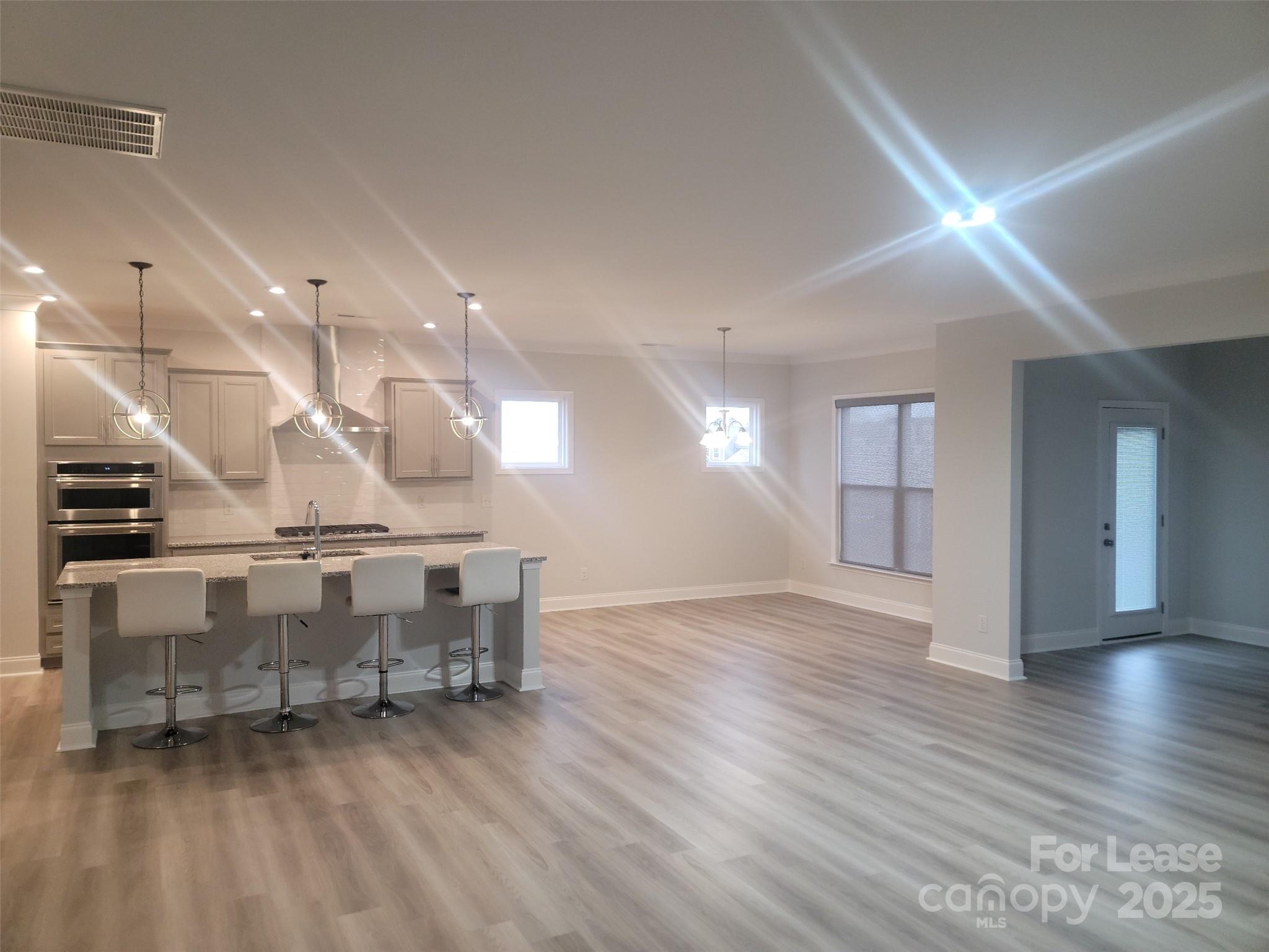 1115 Kalli Drive Matthews, NC 28104 - Photo 17 of 22 a view of an empty room with window and wooden floor