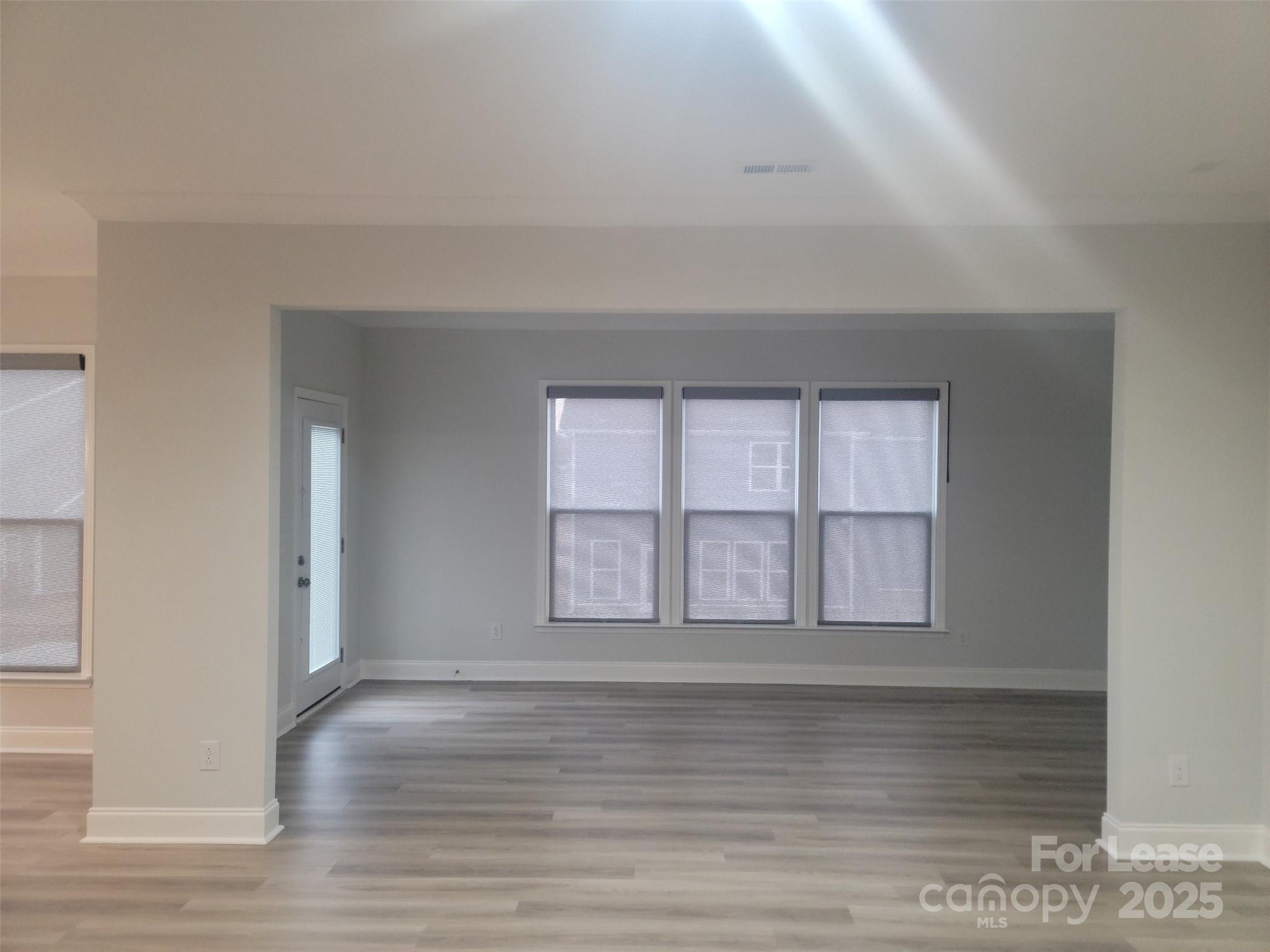 1115 Kalli Drive Matthews, NC 28104 - Photo 20 of 22 a view of an empty room with wooden floor and a window