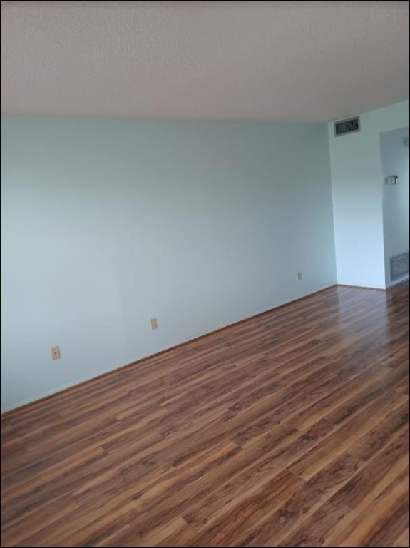 Undisclosed Address Vero Beach, FL 32962 - Photo 11 of 30 a view of an empty room with wooden floor
