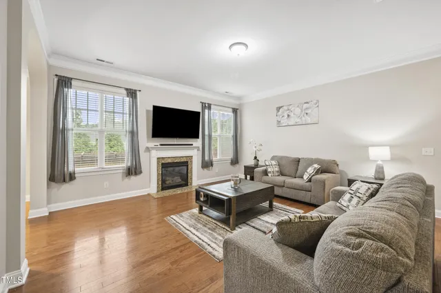a living room with fireplace furniture and a flat screen tv