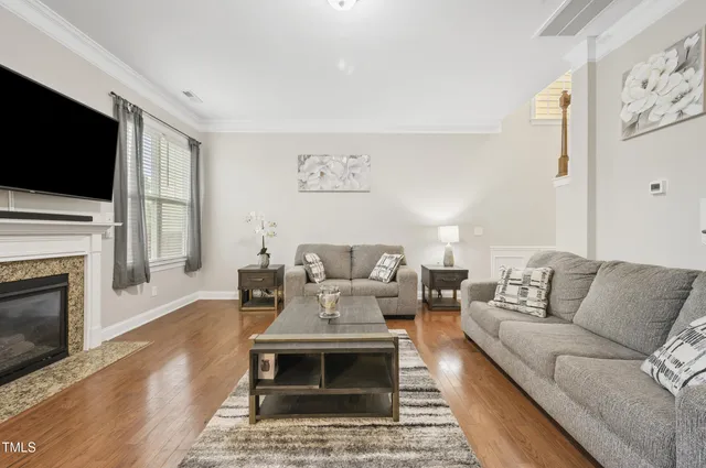 a living room with furniture a fireplace and a flat screen tv