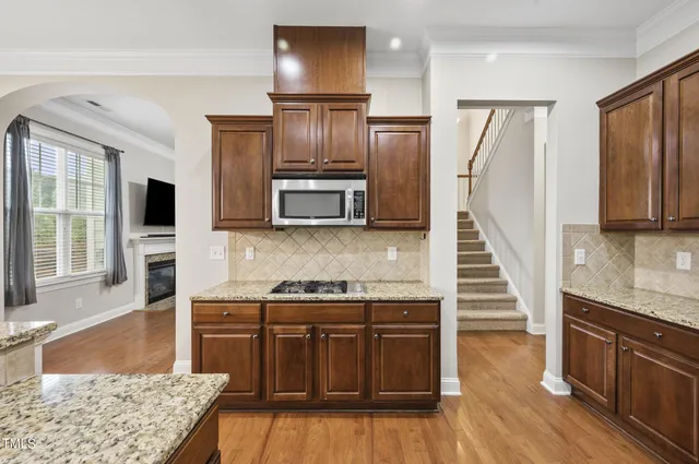 a kitchen with stainless steel appliances granite countertop a refrigerator oven a sink and dishwasher