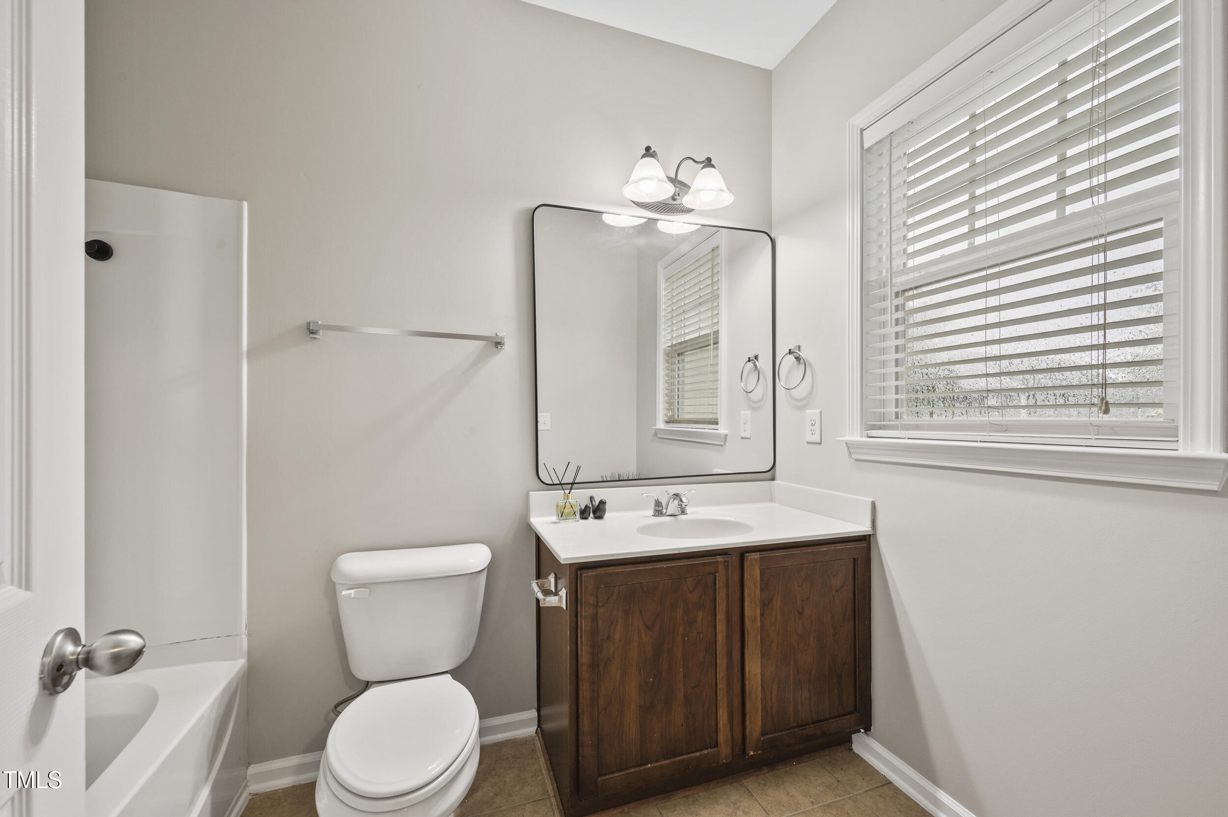 1204 Chapanoke Road Raleigh, NC 27603 - Photo 25 of 45 a bathroom with a toilet sink and mirror