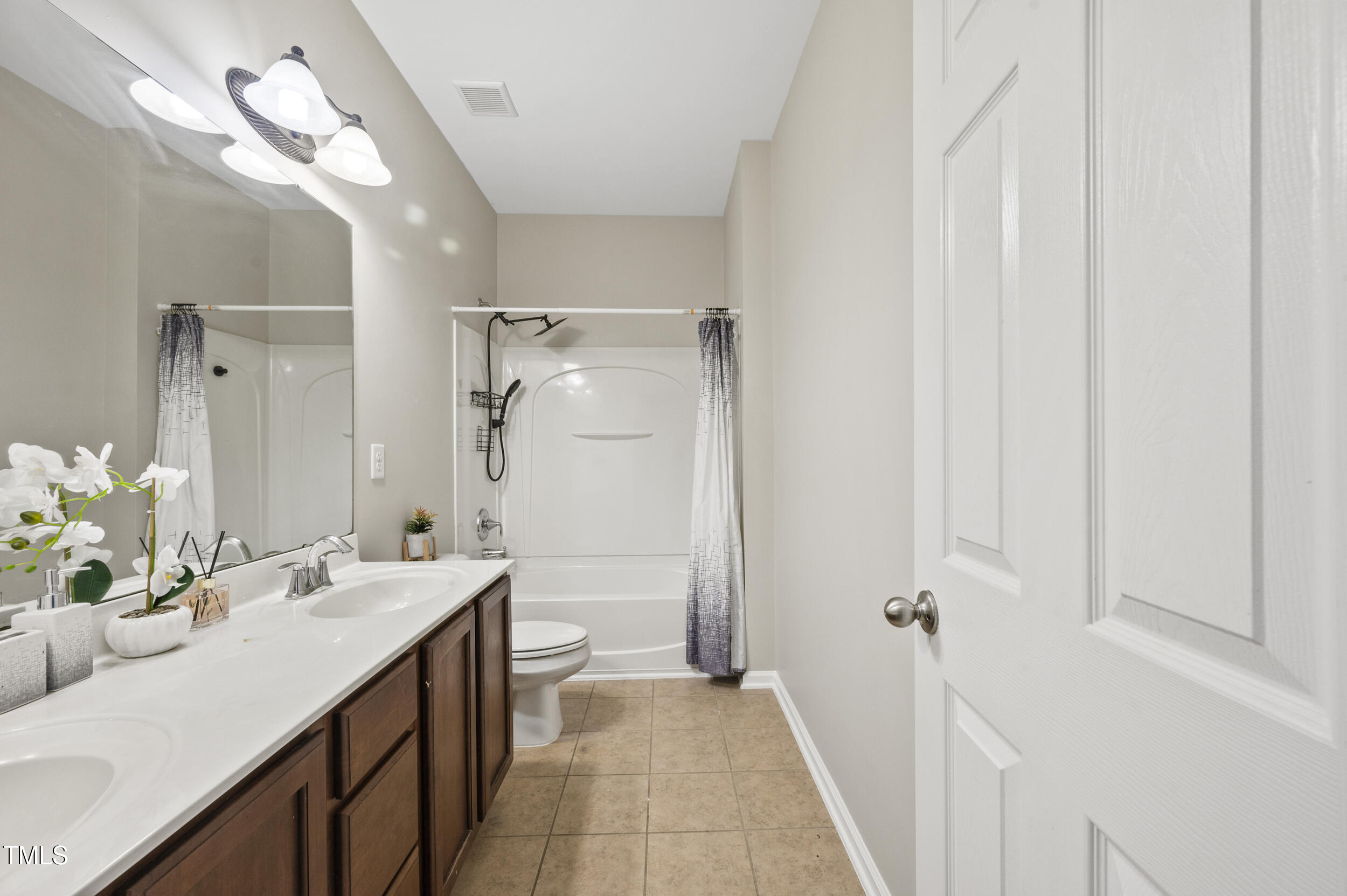 1204 Chapanoke Road Raleigh, NC 27603 - Photo 26 of 45 a bathroom with a sink a toilet and shower
