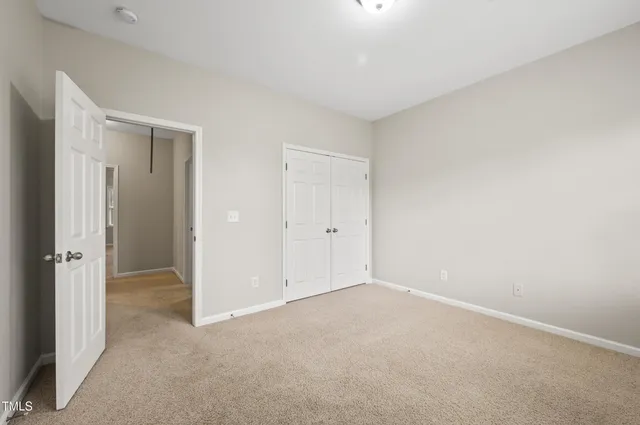 a living room with couch cabinet and a flat screen tv