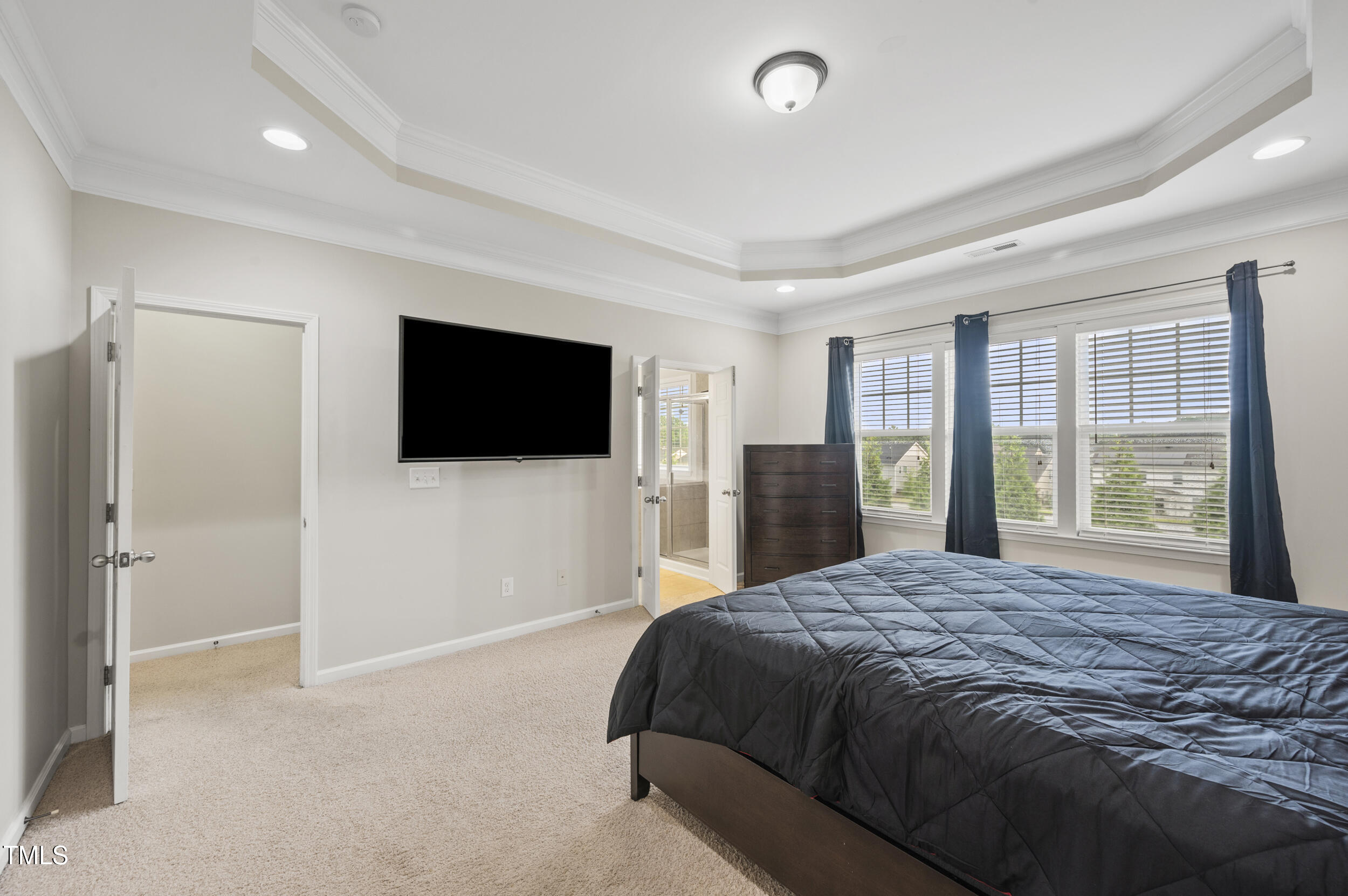 1204 Chapanoke Road Raleigh, NC 27603 - Photo 35 of 45 a spacious bedroom with a large bed and a flat screen tv