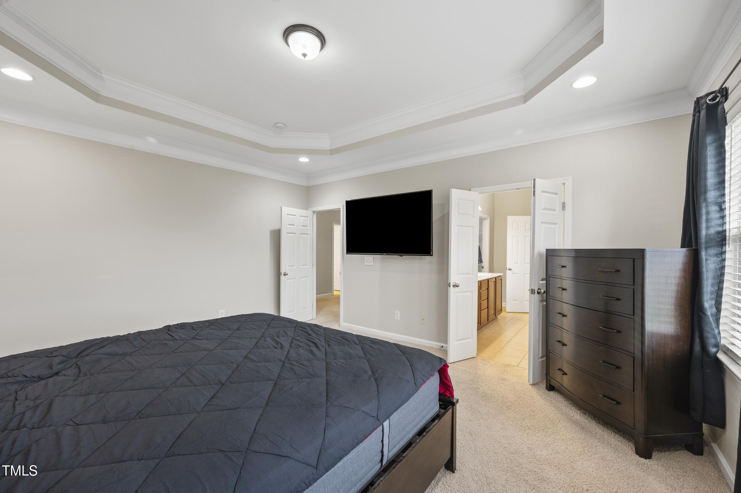 1204 Chapanoke Road Raleigh, NC 27603 - Photo 36 of 45 a bedroom with a bed and a flat screen tv