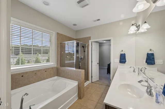 a white bath tub sitting next to a toilet