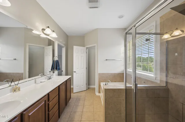 a bathroom with a tub sink and mirror