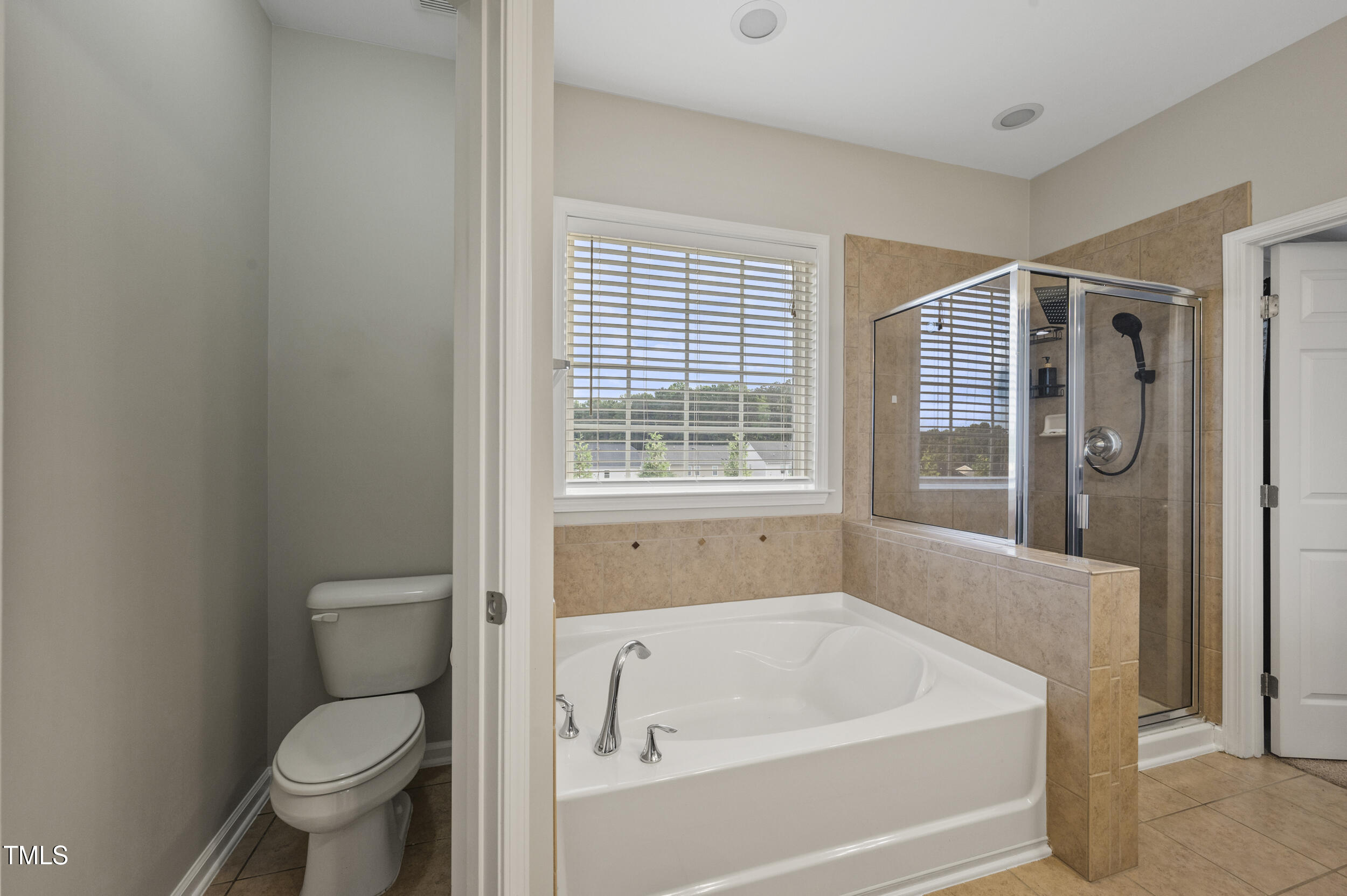 1204 Chapanoke Road Raleigh, NC 27603 - Photo 39 of 45 a white bath tub sitting next to a toilet