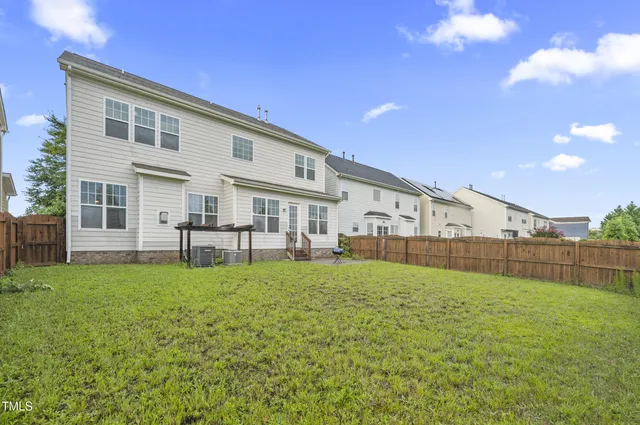 a view of a house with a yard and sitting area
