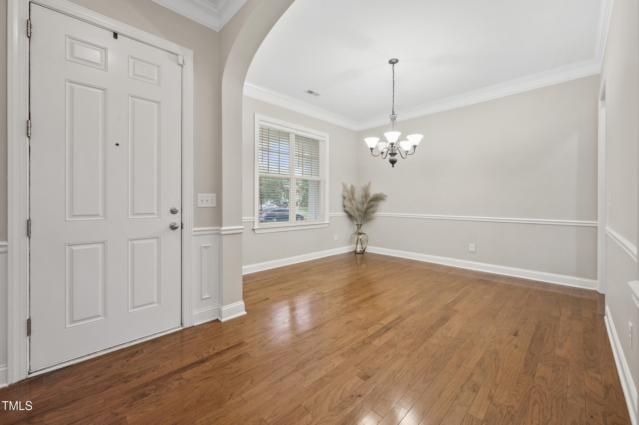 1204 Chapanoke Road Raleigh, NC 27603 - Photo 6 of 45 a view of a livingroom with wooden floor closet and windows