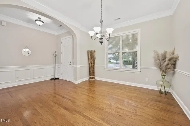 a view of a livingroom with wooden floor closet and windows