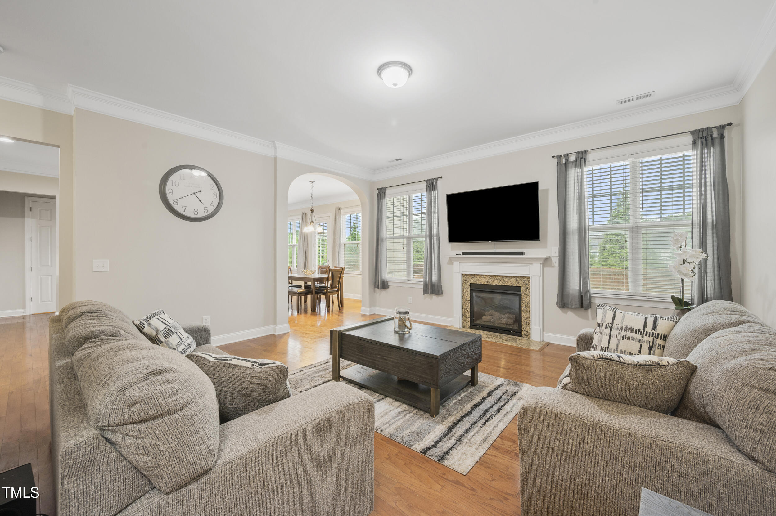 1204 Chapanoke Road Raleigh, NC 27603 - Photo 8 of 45 a living room with furniture a fireplace and a flat screen tv