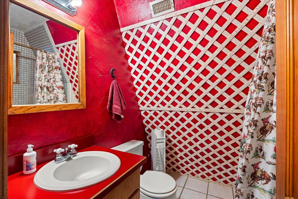 1601 Stafford Road Weatherford, TX 76088 - Photo 14 of 40 a bathroom with a sink and a mirror with toilet