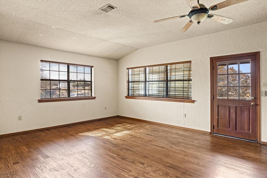 1601 Stafford Road Weatherford, TX 76088 - Photo 25 of 40 a view of an empty room with a window and wooden floor