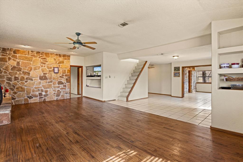 1601 Stafford Road Weatherford, TX 76088 - Photo 26 of 40 a view of a livingroom with wooden floor and a ceiling fan