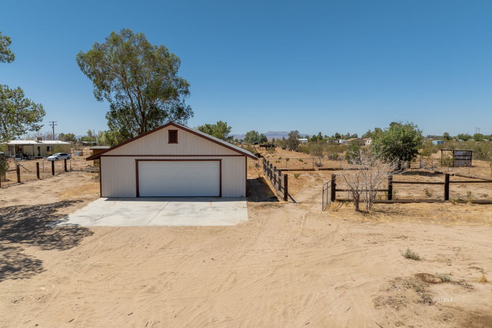 3443 3rd Street Inyokern, CA 93527 - Photo 18 of 24 a backyard of a house with large trees and outdoor seating