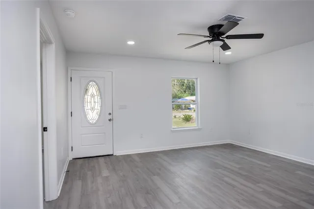 wooden floor in an empty room with a window