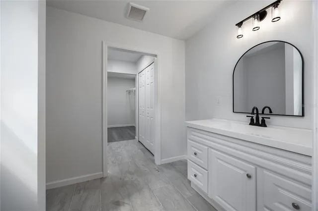 a bathroom with a sink and mirror