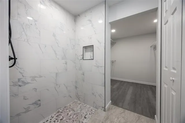 a bathroom with a shower and a sink