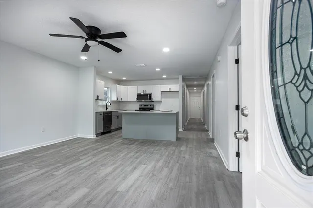 a view of a kitchen with a sink and wooden floor
