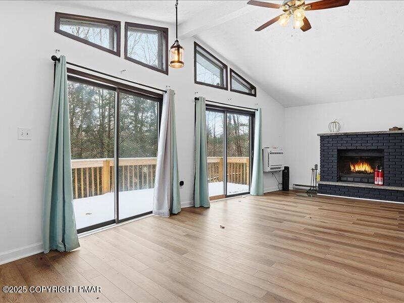 2167 Freedom Way Pocono Summit, PA 18346 - Photo 44 of 45 a view of an empty room with wooden floor and a fireplace