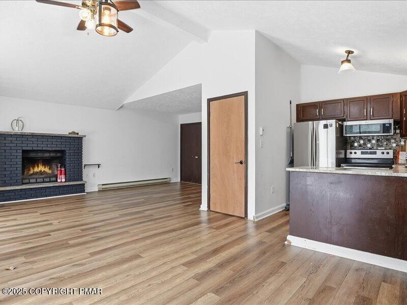 2167 Freedom Way Pocono Summit, PA 18346 - Photo 14 of 45 a view of a livingroom with wooden floor and a fireplace