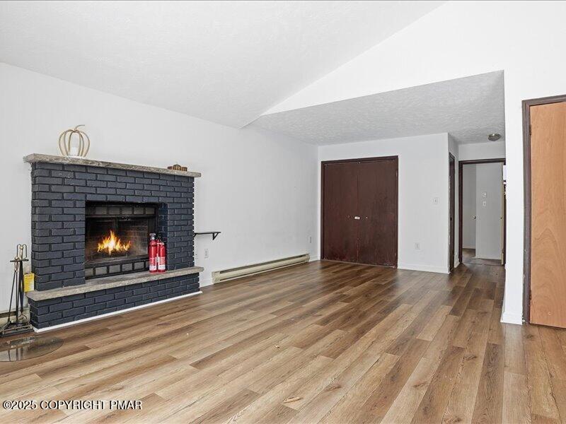 2167 Freedom Way Pocono Summit, PA 18346 - Photo 15 of 45 a view of an empty room with wooden floor fireplace and a window