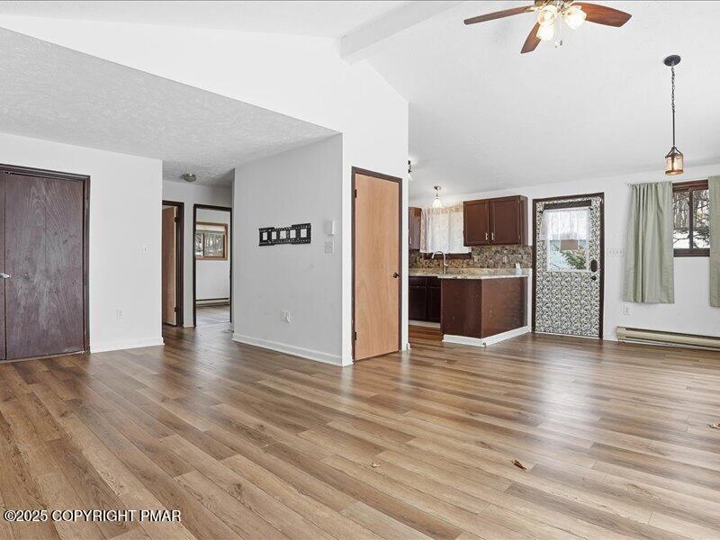 2167 Freedom Way Pocono Summit, PA 18346 - Photo 45 of 45 a view of a kitchen with a fridge wooden floor and a ceiling fan