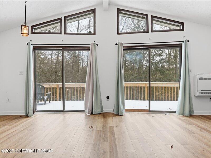 2167 Freedom Way Pocono Summit, PA 18346 - Photo 16 of 45 a view of a room with wooden floor and a large window