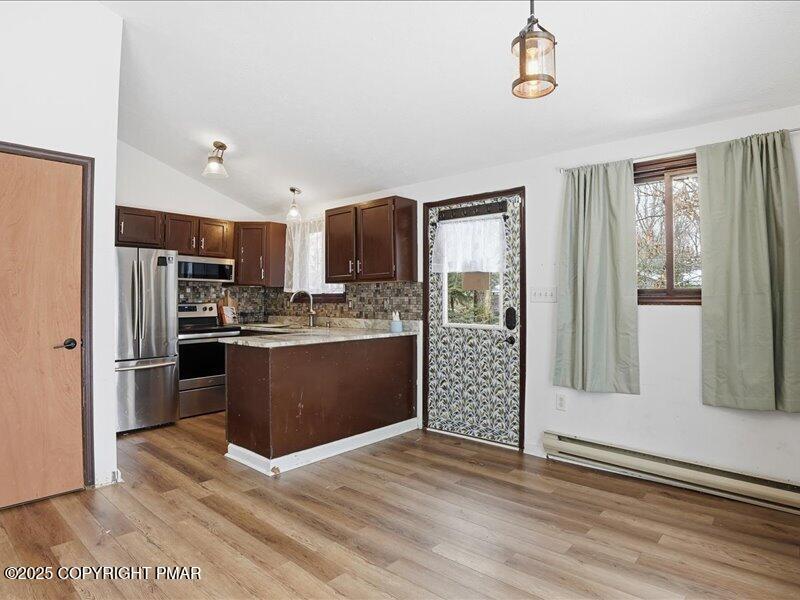 2167 Freedom Way Pocono Summit, PA 18346 - Photo 17 of 45 a kitchen with stainless steel appliances kitchen island granite countertop a refrigerator and a sink