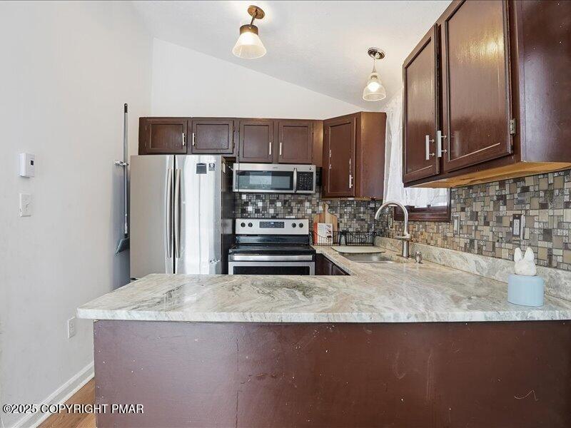 2167 Freedom Way Pocono Summit, PA 18346 - Photo 18 of 45 a kitchen with stainless steel appliances granite countertop a sink stove and refrigerator