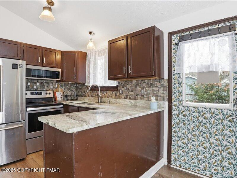 2167 Freedom Way Pocono Summit, PA 18346 - Photo 19 of 45 a kitchen with a sink a stove a refrigerator and a window