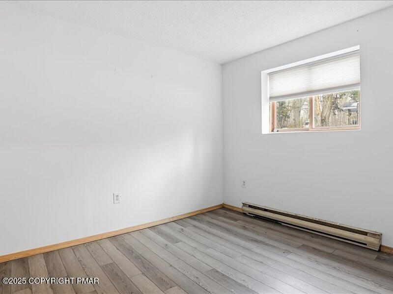 2167 Freedom Way Pocono Summit, PA 18346 - Photo 28 of 45 an empty room with wooden floor and windows