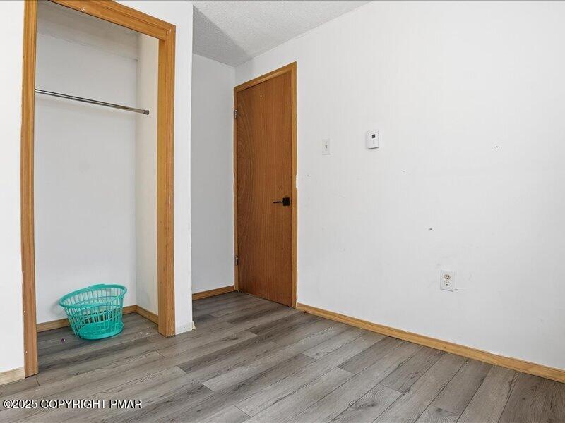 2167 Freedom Way Pocono Summit, PA 18346 - Photo 29 of 45 a view of an empty room with wooden floor and a window
